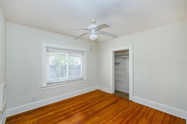 3108 Dupont St S, Gulfport, FL 33707 - unfurnished bedroom featuring wood-type flooring, baseboards, a closet, and ceiling fan