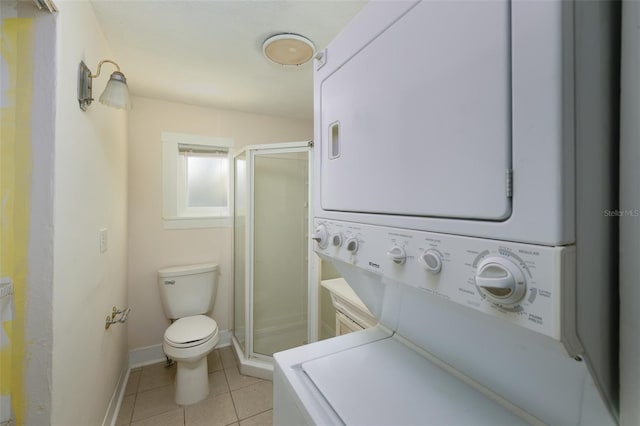 3108 Dupont St S, Gulfport, FL 33707 - full bathroom with stacked washer and clothes dryer, toilet, a shower stall, and tile patterned floors