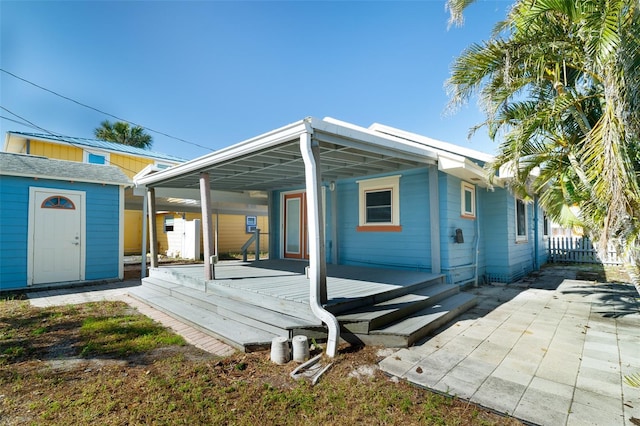 3108 Dupont St S, Gulfport, FL 33707 - rear view of property featuring a storage shed, an outdoor structure, and fence