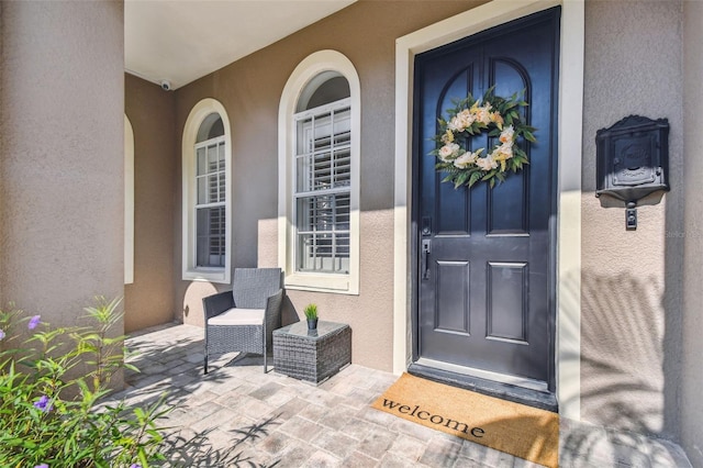 407 S Fremont Ave Unit B, Tampa, FL 33606 - entrance to property featuring stucco siding, a porch, and a surveillance system