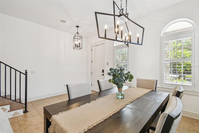 407 S Fremont Ave Unit B, Tampa, FL 33606 - dining area featuring a chandelier, stairway, light tile patterned flooring, and baseboards