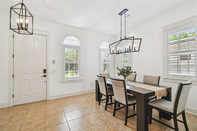 407 S Fremont Ave Unit B, Tampa, FL 33606 - dining area featuring a chandelier, baseboards, and light tile patterned floors