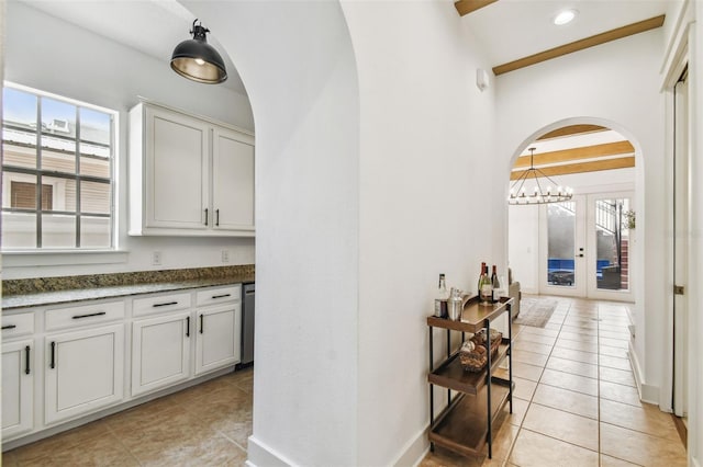 407 S Fremont Ave Unit B, Tampa, FL 33606 - bar area featuring arched walkways, light tile patterned floors, and healthy amount of natural light
