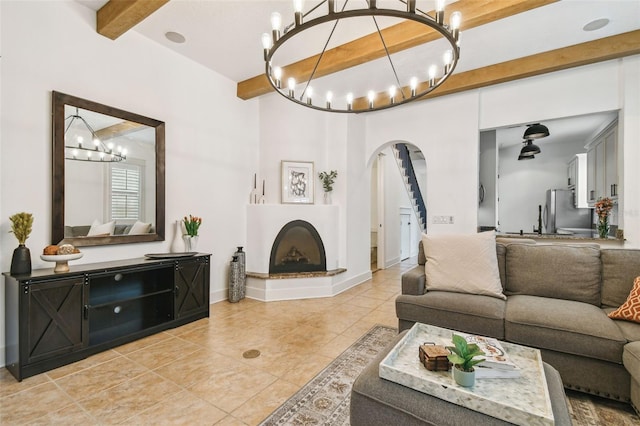 407 S Fremont Ave Unit B, Tampa, FL 33606 - living area with a chandelier, arched walkways, light tile patterned flooring, beamed ceiling, and a fireplace with raised hearth