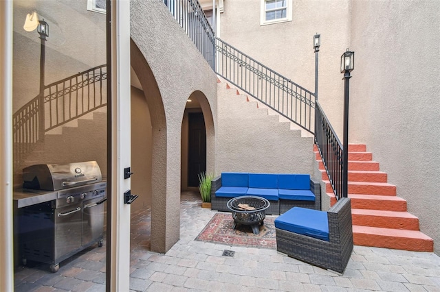 407 S Fremont Ave Unit B, Tampa, FL 33606 - view of patio / terrace featuring stairway, area for grilling, and an outdoor living space with a fire pit