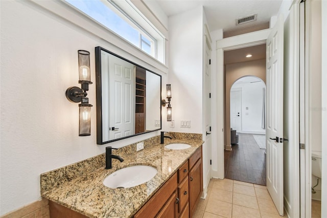 407 S Fremont Ave Unit B, Tampa, FL 33606 - bathroom featuring double vanity, tile patterned floors, and baseboards