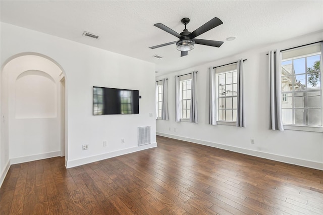 407 S Fremont Ave Unit B, Tampa, FL 33606 - unfurnished living room with a ceiling fan, hardwood / wood-style flooring, a textured ceiling, and arched walkways
