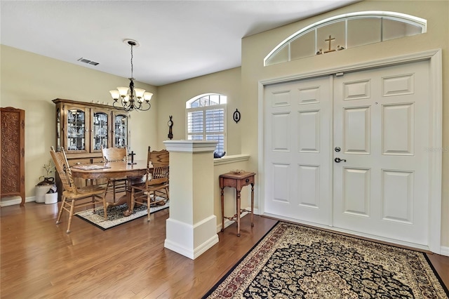 12012 Cromwell Way, Spring Hill, FL 34609 - entryway featuring wood finished floors, a chandelier, and baseboards