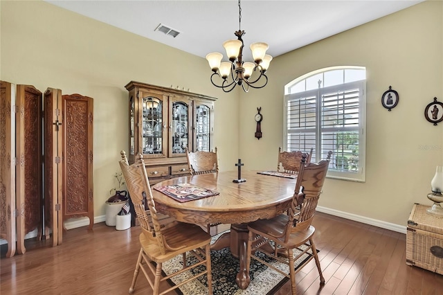 12012 Cromwell Way, Spring Hill, FL 34609 - dining space featuring dark wood-type flooring, a chandelier, and baseboards