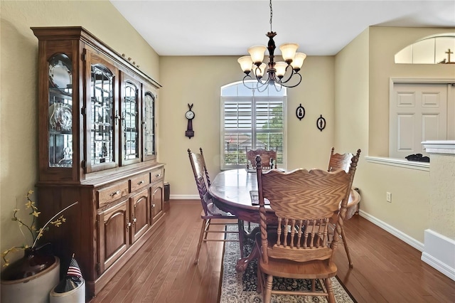 12012 Cromwell Way, Spring Hill, FL 34609 - dining area featuring a chandelier, dark wood-type flooring, and baseboards