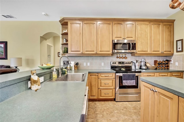 12012 Cromwell Way, Spring Hill, FL 34609 - kitchen with stainless steel appliances, a sink, arched walkways, decorative backsplash, and open shelves
