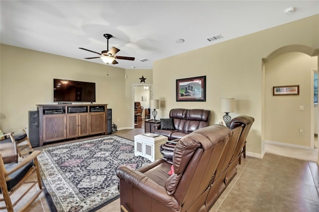 12012 Cromwell Way, Spring Hill, FL 34609 - living area with arched walkways, ceiling fan, baseboards, and light tile patterned floors