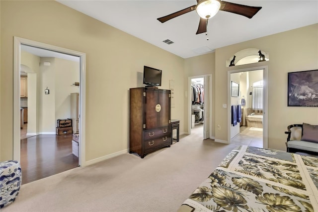 12012 Cromwell Way, Spring Hill, FL 34609 - bedroom with a spacious closet, light carpet, ensuite bath, baseboards, and a closet