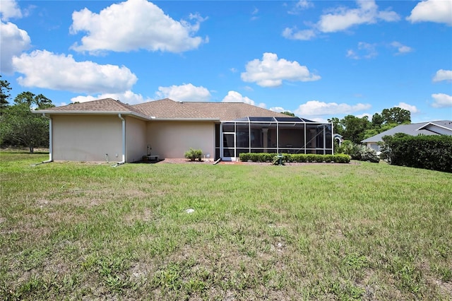12012 Cromwell Way, Spring Hill, FL 34609 - rear view of house with stucco siding, a yard, and glass enclosure
