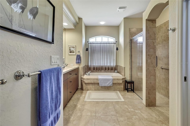 12012 Cromwell Way, Spring Hill, FL 34609 - bathroom with a shower stall, a garden tub, vanity, and tile patterned floors