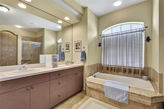 12012 Cromwell Way, Spring Hill, FL 34609 - full bathroom featuring a bath, double vanity, a stall shower, recessed lighting, and tile patterned floors
