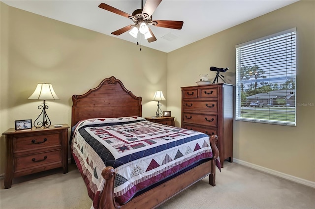 12012 Cromwell Way, Spring Hill, FL 34609 - bedroom with light colored carpet, baseboards, and a ceiling fan