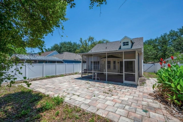 5865 Meadowpark Pl, Lithia, FL 33547 - back of property featuring a sunroom, a patio, a fenced backyard, and roof with shingles