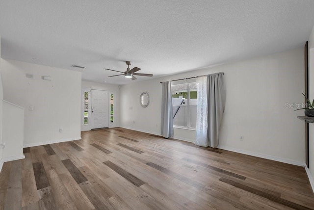 5865 Meadowpark Pl, Lithia, FL 33547 - unfurnished living room featuring a ceiling fan, wood finished floors, a textured ceiling, and baseboards
