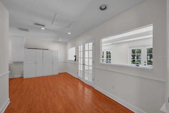 5865 Meadowpark Pl, Lithia, FL 33547 - empty room featuring wood finished floors, baseboards, french doors, recessed lighting, and attic access