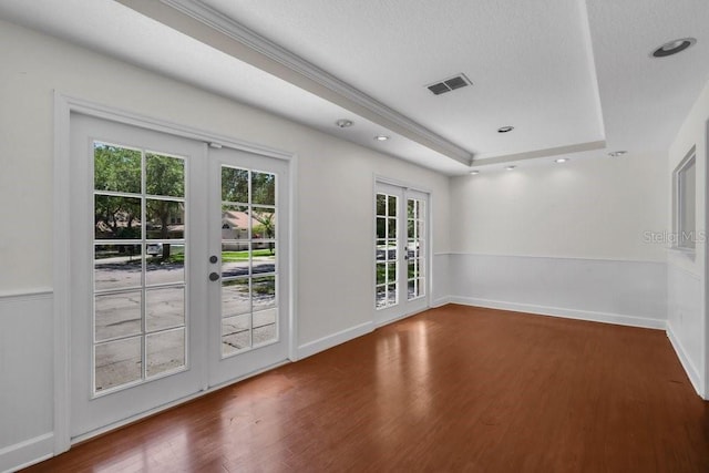 5865 Meadowpark Pl, Lithia, FL 33547 - empty room featuring french doors, wood finished floors, a tray ceiling, and a textured ceiling