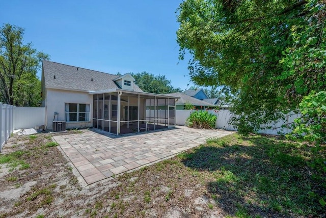 5865 Meadowpark Pl, Lithia, FL 33547 - rear view of house with a sunroom, a patio area, and a fenced backyard