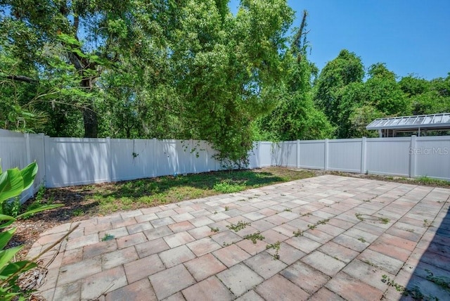 5865 Meadowpark Pl, Lithia, FL 33547 - fenced backyard featuring a patio area