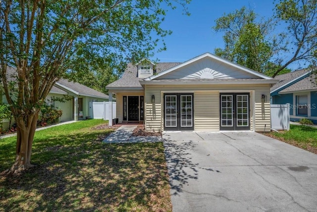 5865 Meadowpark Pl, Lithia, FL 33547 - view of front of house featuring french doors and roof with shingles