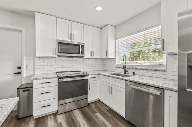 1459 Joel Ln, Clearwater, FL 33755 - kitchen with appliances with stainless steel finishes, a sink, white cabinets, light stone countertops, and recessed lighting