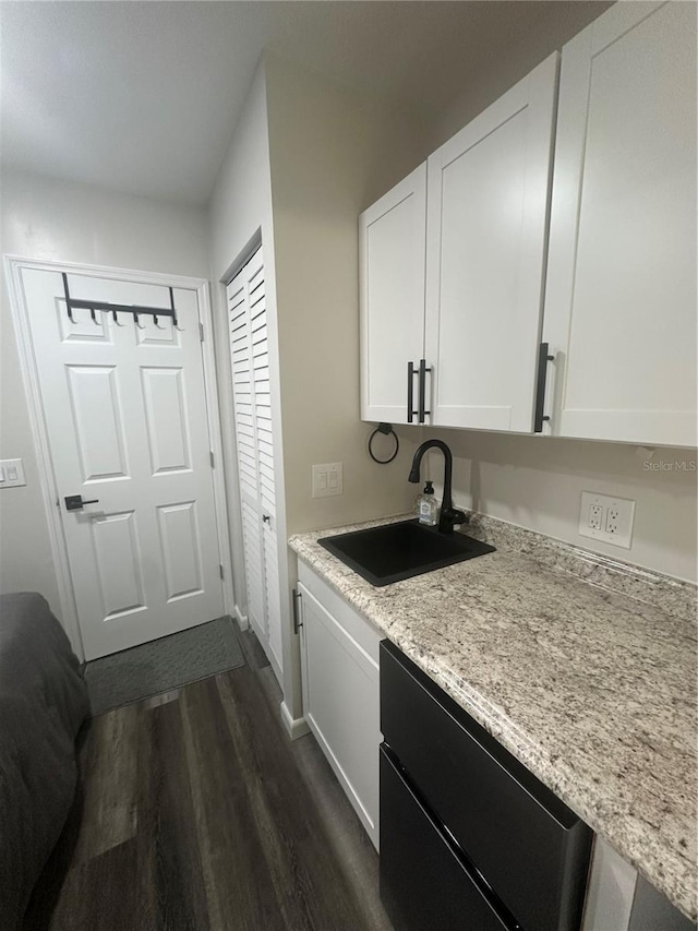 1459 Joel Ln, Clearwater, FL 33755 - kitchen featuring a sink, dark wood-type flooring, white cabinetry, baseboards, and dishwasher