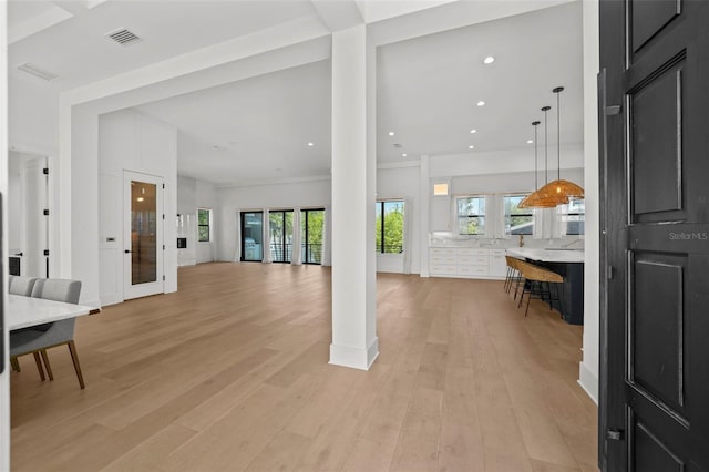 403 E Davis Blvd, Tampa, FL 33606 - living area featuring ornate columns, light wood-type flooring, healthy amount of natural light, and recessed lighting