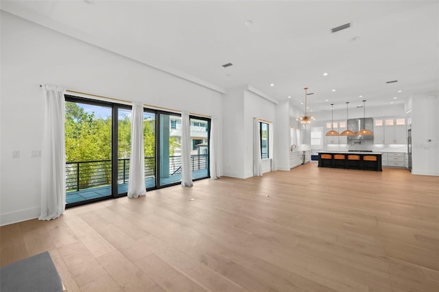 403 E Davis Blvd, Tampa, FL 33606 - unfurnished living room with light wood-style flooring, baseboards, and recessed lighting