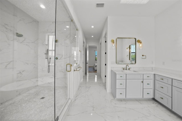 403 E Davis Blvd, Tampa, FL 33606 - bathroom with marble tiled floors, a marble finish shower, recessed lighting, and vanity