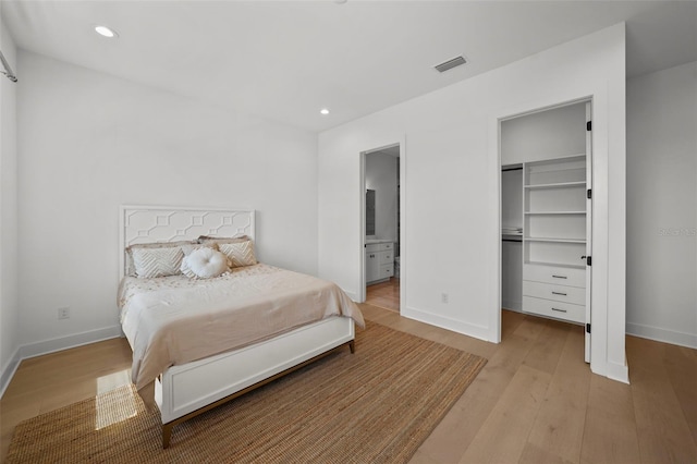 403 E Davis Blvd, Tampa, FL 33606 - bedroom featuring a walk in closet, light wood-style floors, baseboards, recessed lighting, and connected bathroom