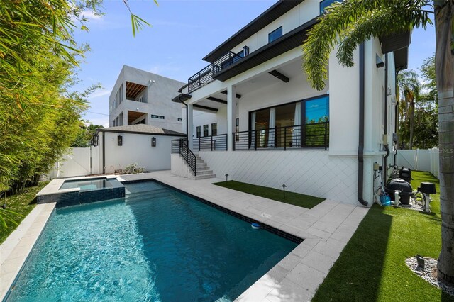 403 E Davis Blvd, Tampa, FL 33606 - rear view of property with a pool with connected hot tub, stairway, stucco siding, and a patio