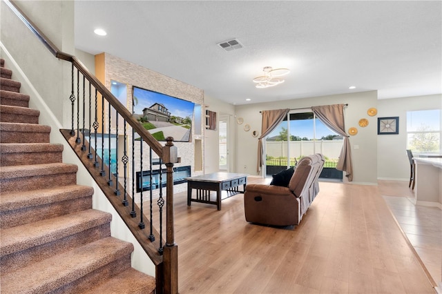 4917 Eagle Rock Dr, Wimauma, FL 33598 - living area with stairs, light wood-style flooring, baseboards, and recessed lighting