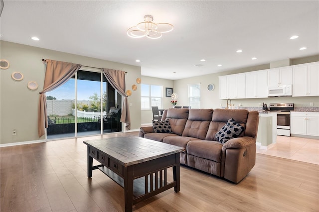 4917 Eagle Rock Dr, Wimauma, FL 33598 - living area with light wood-style flooring, recessed lighting, and baseboards