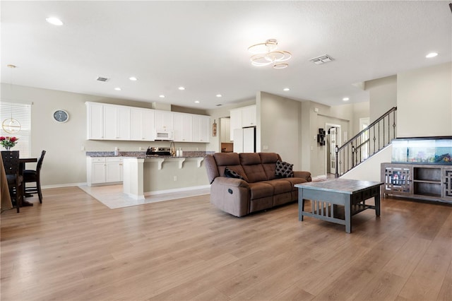 4917 Eagle Rock Dr, Wimauma, FL 33598 - living area with light wood-type flooring, recessed lighting, and baseboards