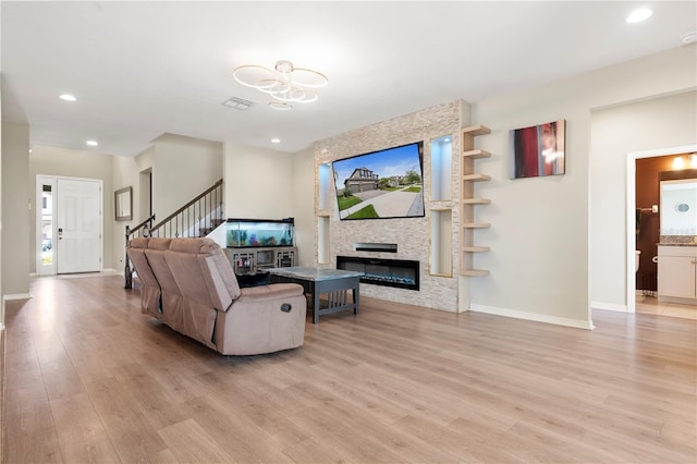 4917 Eagle Rock Dr, Wimauma, FL 33598 - living area featuring light wood-type flooring, baseboards, a fireplace, recessed lighting, and stairway