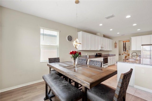 4917 Eagle Rock Dr, Wimauma, FL 33598 - dining area with recessed lighting, baseboards, and light wood-type flooring