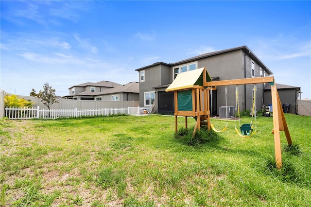 4917 Eagle Rock Dr, Wimauma, FL 33598 - back of property with a playground, cooling unit, and stucco siding