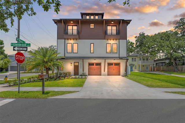 2200 N Glenwood Dr, Tampa, FL 33602 - view of front of house featuring a balcony, a garage, driveway, and stucco siding
