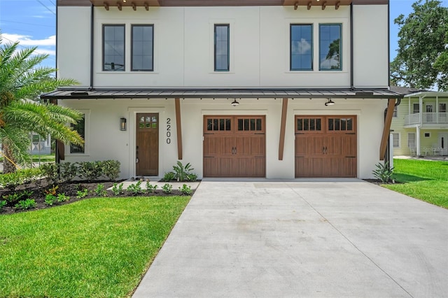 2200 N Glenwood Dr, Tampa, FL 33602 - townhome / multi-family property with a standing seam roof, concrete driveway, stucco siding, a front lawn, and a garage