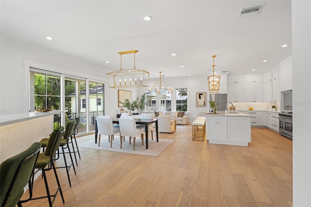 2200 N Glenwood Dr, Tampa, FL 33602 - dining area with a chandelier, light wood finished floors, plenty of natural light, and recessed lighting