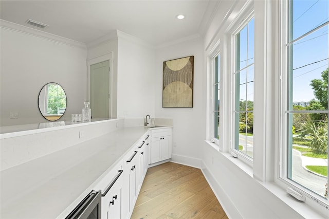 2200 N Glenwood Dr, Tampa, FL 33602 - bathroom with vanity, plenty of natural light, wood finished floors, ornamental molding, and baseboards