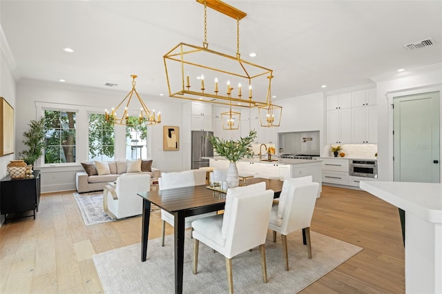 2200 N Glenwood Dr, Tampa, FL 33602 - dining space featuring a chandelier, recessed lighting, light wood finished floors, and crown molding