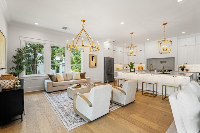 2200 N Glenwood Dr, Tampa, FL 33602 - living room with a chandelier, light wood-style floors, recessed lighting, baseboards, and crown molding