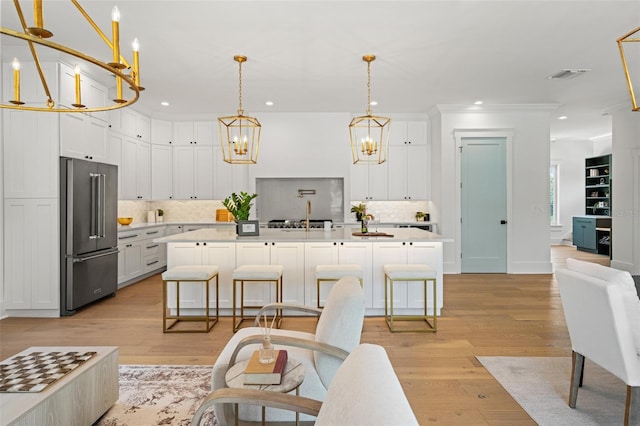 2200 N Glenwood Dr, Tampa, FL 33602 - kitchen with high end refrigerator, a chandelier, decorative backsplash, light countertops, and recessed lighting