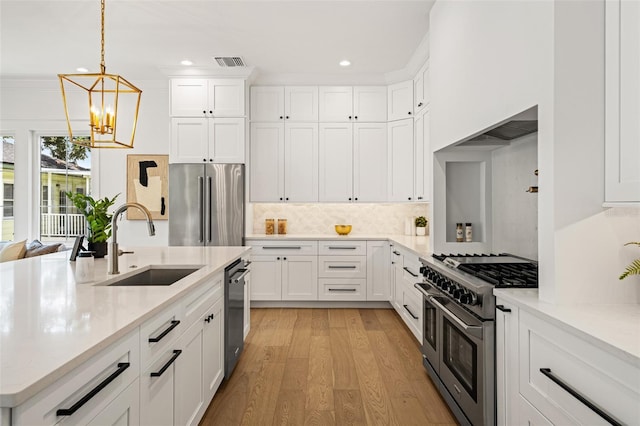 2200 N Glenwood Dr, Tampa, FL 33602 - kitchen featuring high quality appliances, a sink, a chandelier, recessed lighting, and backsplash