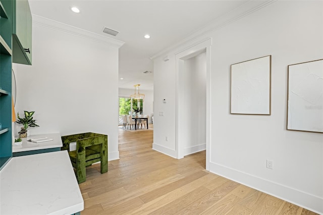 2200 N Glenwood Dr, Tampa, FL 33602 - hall with crown molding, light wood finished floors, baseboards, recessed lighting, and a chandelier